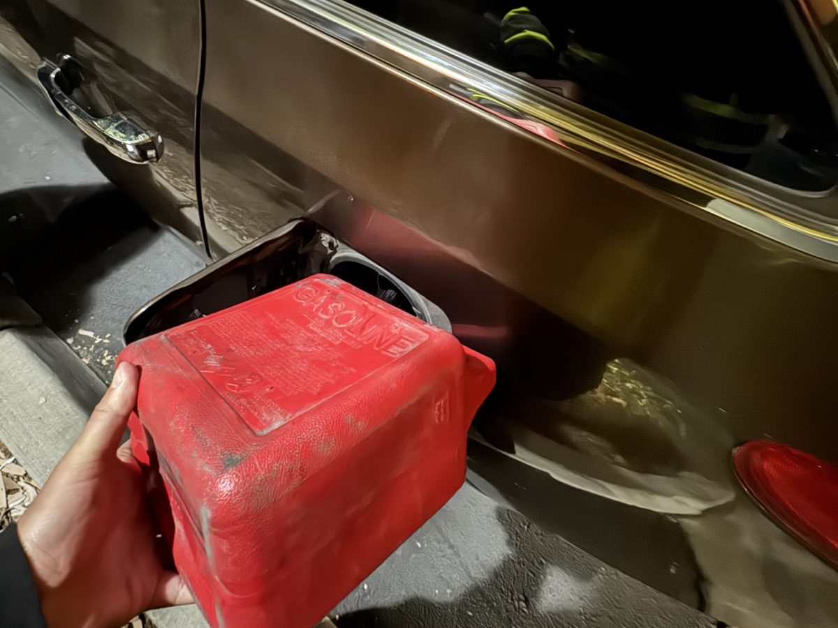 Technician delivering fuel to a car